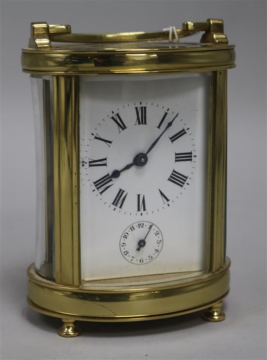 A French brass oval carriage timepiece with alarm